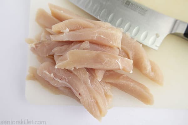 raw chicken cut in strips