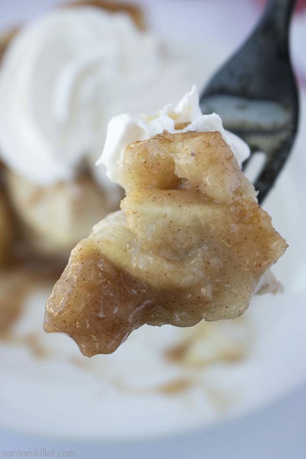 Apple pie with whipped cram on a fork