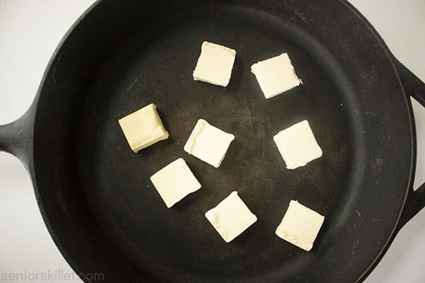 butter pats in a cast iron skillet