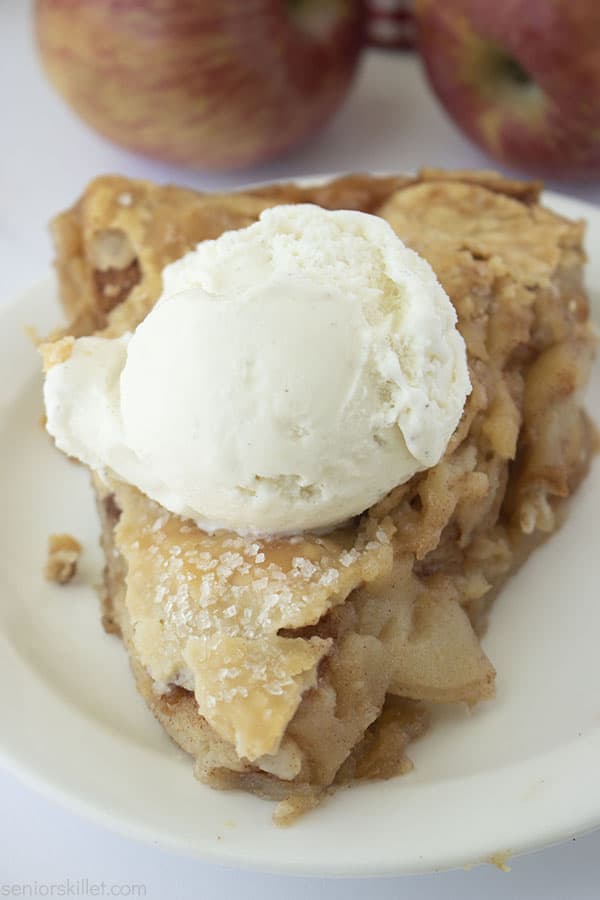 Piece of Two Layer Skillet Apple Pie on a plate with Ice Cream
