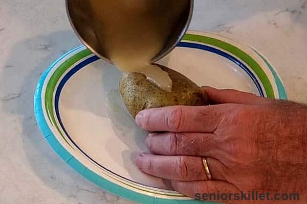Lathering potato with bacon grease