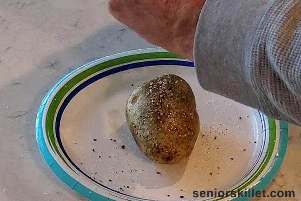 Adding salt and pepper to potatoes