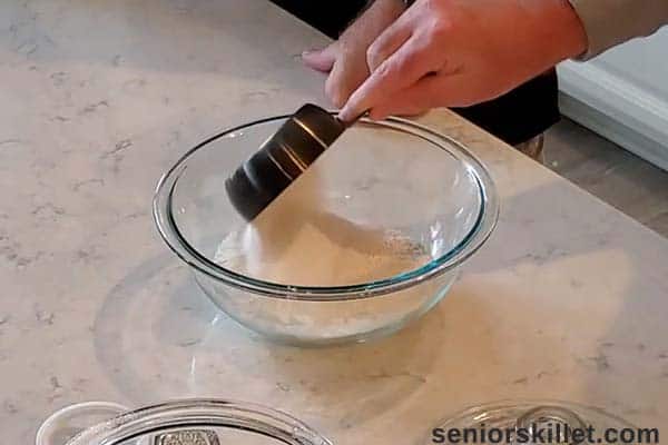 Adding cobbler ingredients to a bowl