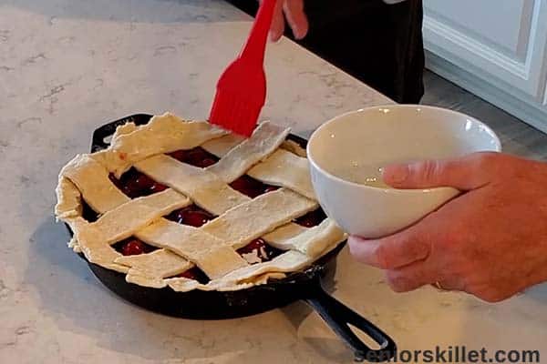 Egg washing the top of pie crust