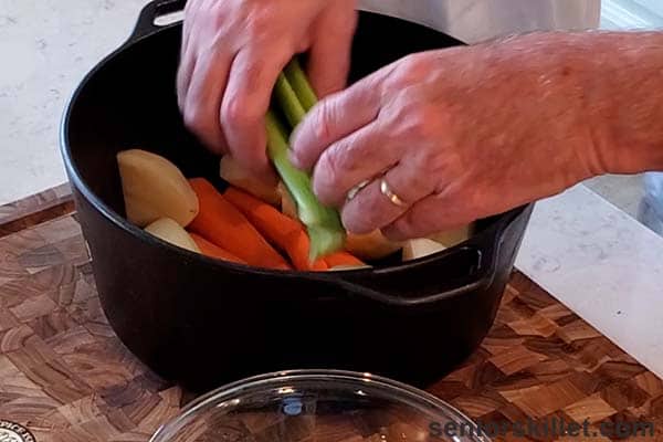 Adding the veggies to the pot