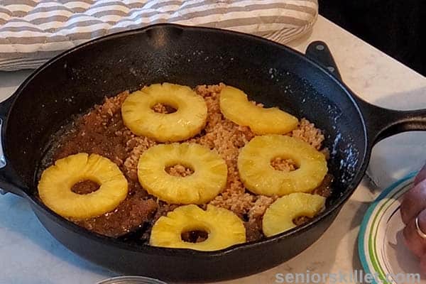 Pineapple rings added to pan