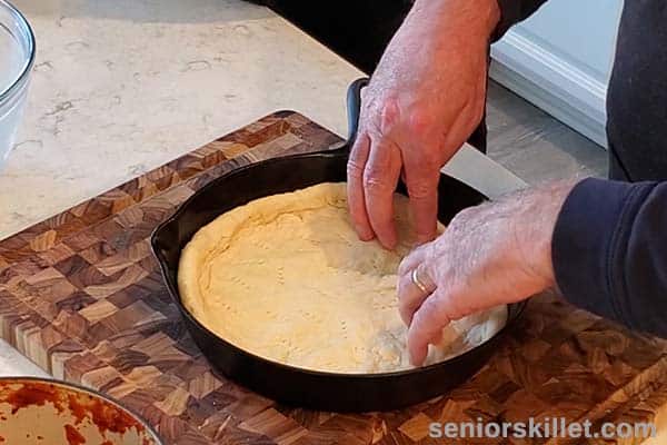 Putting dough into skillet