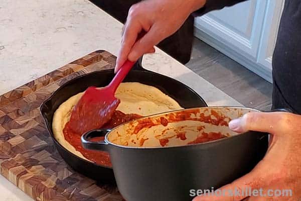 Putting sauce on crust