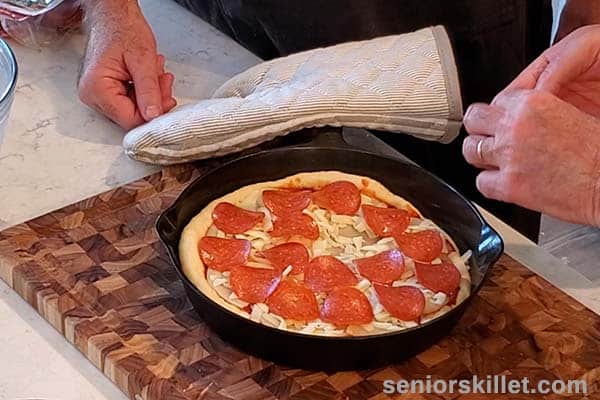 Adding pepperoni to pizza