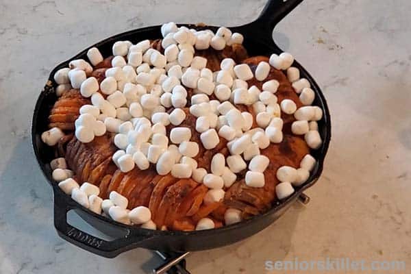 Marshmallows added to tops of potatoes