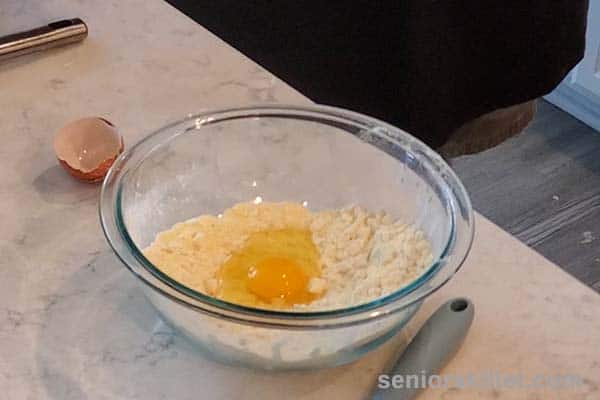 Adding egg to bowl