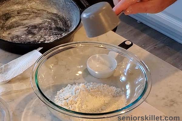 Adding dry ingredients to mixing bowl